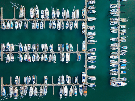 Aerial view of Bangor Harbour and Town with numerous yachts and sailboats moored in the marina calm turquoise water and orderly wooden piers Bangor Northern Ireland United Kingdom.