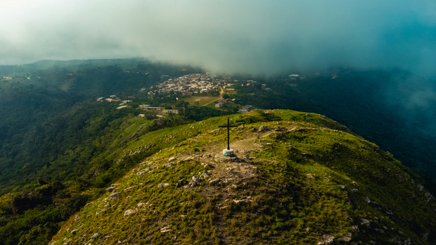 Aerial view of the cross atop Mt. Gemi overlooking the lush green hills and the village of Amedzofe Volta Region Ghana. Aerial view of the cross atop Mt. Gemi overlooking the lush green hills and the village of Amedzofe Volta Region Ghana.