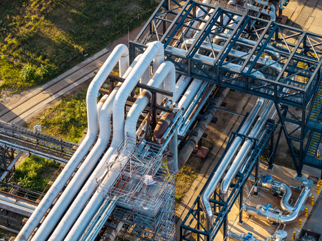 Aerial view of the Heizkraftwerk Klingenberg combined heat and power plant featuring large white industrial pipes and metal scaffolding in Berlin Berlin Germany. Aerial view of the Heizkraftwerk Klingenberg combined heat and power plant featuring large white industrial pipes and metal scaffolding in Berlin Berlin Germany.