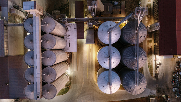 Aerial view of industrial grain silos illuminated at night in Sremska Mitrovica Vojvodina Serbia. Aerial view of industrial grain silos illuminated at night in Sremska Mitrovica Vojvodina Serbia.