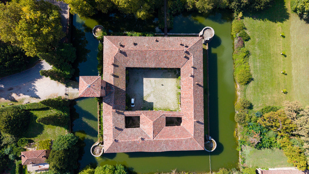 Peschiera Borromeo Italy 19 September 2026 Aerial view of Castello di Peschiera Borromeo a historic moated castle with a square courtyard and red tiled roofs.