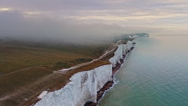 Aerial view of Seven Sisters Cliffs and misty hills United Kingdom. Aerial view of Seven Sisters Cliffs and misty hills United Kingdom.