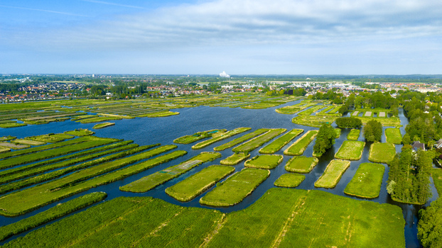 Aerial view of the Oosterdel nature reserve with its unique thousand islands landscape and lush green fields in Broek op Langedijk Noord Holland Netherlands. Aerial view of the Oosterdel nature reserve with its unique thousand islands landscape and lush green fields in Broek op Langedijk Noord Holland Netherlands.