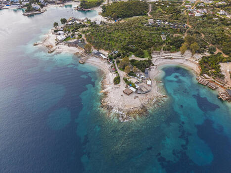 Aerial view of the coastal landscape of Ksamil featuring turquoise waters sandy beaches and Mediterranean vegetation in Ksamil Vlore County Albania. Aerial view of the coastal landscape of Ksamil featuring turquoise waters sandy beaches and Mediterranean vegetation in Ksamil Vlore County Albania.