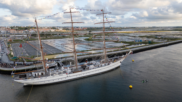 Aerial view of the tall ship NRP Sagres decorated with signal flags navigating the Canal de Aveiro near the salt pans Aveiro Aveiro Portugal. Aerial view of the tall ship NRP Sagres decorated with signal flags navigating the Canal de Aveiro near the salt pans Aveiro Aveiro Portugal.
