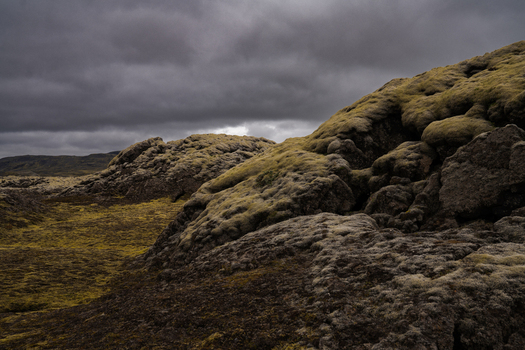 View of moss covered volcanic rocks under a stormy sky create a scene of stark beauty and isolation Skaftárhreppur Skaftárhreppur Iceland. View of moss covered volcanic rocks under a stormy sky create a scene of stark beauty and isolation Skaftárhreppur Skaftárhreppur Iceland.