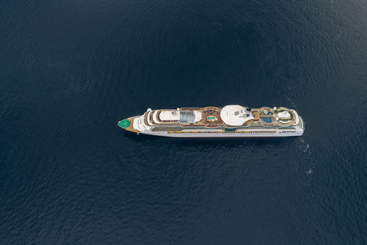 Aerial view of a large cruise ship sailing on the deep blue Mediterranean Sea near Cannes Provence Alpes Cote d Azur France. Aerial view of a large cruise ship sailing on the deep blue Mediterranean Sea near Cannes Provence Alpes Cote d Azur France.