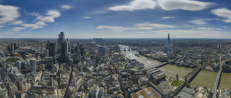 Aerial view of The Fenchurch Building and the London skyline with The Shard Tower Bridge and the River Thames under a blue sky London England United Kingdom. Aerial view of The Fenchurch Building and the London skyline with The Shard Tower Bridge and the River Thames under a blue sky London England United Kingdom.
