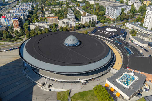 Katowice Poland 17 September 2026 Aerial view of the Spodek arena featuring its iconic saucer shaped roof and central dome surrounded by urban buildings and green spaces.