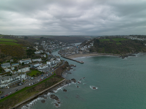 Aerial view of Banjo Pier and the coastal town nestled along the river estuary in Looe Cornwall United Kingdom. Aerial view of Banjo Pier and the coastal town nestled along the river estuary in Looe Cornwall United Kingdom.