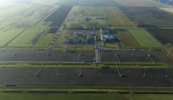 Aerial view of the natural gas mining facility with industrial infrastructure pipes and surrounding agricultural fields Slochteren Groningen Netherlands. Aerial view of the natural gas mining facility with industrial infrastructure pipes and surrounding agricultural fields Slochteren Groningen Netherlands.