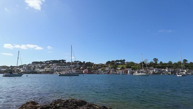 View of boats on the Fowey River and the town of Fowey United Kingdom. View of boats on the Fowey River and the town of Fowey United Kingdom.