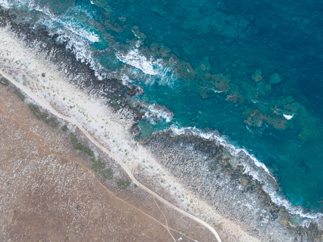 Aerial view of Riserva Naturale Orientata dello Zingaro with rugged coastline turquoise sea rocky shore and a dirt path in San Vito Lo Capo Sicilia Italy. Aerial view of Riserva Naturale Orientata dello Zingaro with rugged coastline turquoise sea rocky shore and a dirt path in San Vito Lo Capo Sicilia Italy.