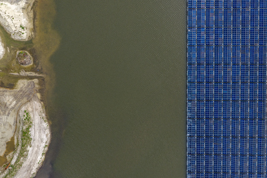 Aerial view of floating solar panels on a calm lake next to a sandy shoreline Beilen Drenthe Netherlands. Aerial view of floating solar panels on a calm lake next to a sandy shoreline Beilen Drenthe Netherlands.