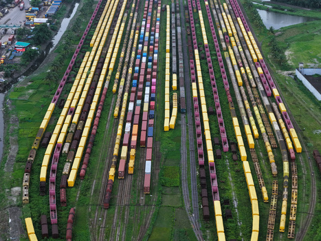 Aerial view of Chattogram Port featuring rows of colorful freight containers loaded on trains parked on railway tracks in the industrial landscape of Chittagong Chittagong Division Bangladesh.