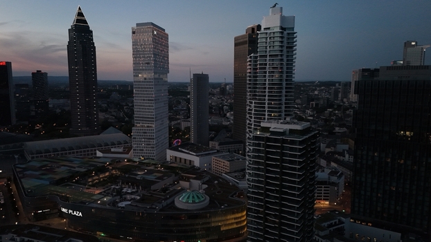 Aerial view of the Frankfurt am Main skyline at dusk featuring modern skyscrapers illuminated office buildings and the MyZeil shopping center in Frankfurt am Main Hessen Germany. Aerial view of the Frankfurt am Main skyline at dusk featuring modern skyscrapers illuminated office buildings and the MyZeil shopping center in Frankfurt am Main Hessen Germany.
