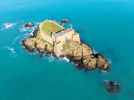 Aerial view of Fort du Petit Bé stands defiantly against the turquoise sea a fortress of weathered stone amidst the crashing waves Saint Malo Bretagne France. Aerial view of Fort du Petit Bé stands defiantly against the turquoise sea a fortress of weathered stone amidst the crashing waves Saint Malo Bretagne France.