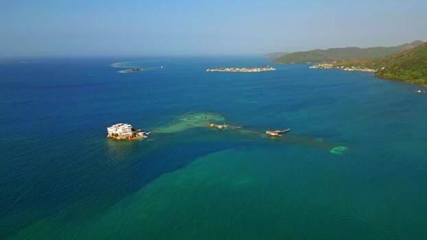 Aerial view of a villa on a small island in Guanaja Honduras.