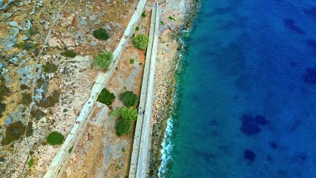 Aerial view of Crete coastline with rocky terrain Greece.