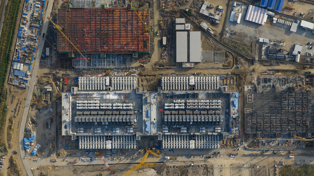 Aerial view of the Bridge Data Center under construction with large industrial buildings cooling systems and construction cranes in Khlong Tamru Chon Buri Thailand. Aerial view of the Bridge Data Center under construction with large industrial buildings cooling systems and construction cranes in Khlong Tamru Chon Buri Thailand.