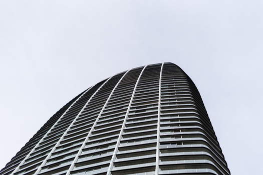 View of the modern curved architecture of a skyscraper with glass balconies against a bright sky in Bratislava Bratislava Region Slovakia. View of the modern curved architecture of a skyscraper with glass balconies against a bright sky in Bratislava Bratislava Region Slovakia.