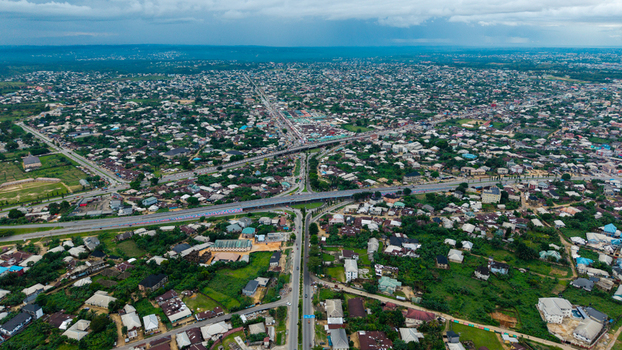 Aerial view of the sprawling urban landscape of Uyo featuring dense residential areas intersecting highways and lush green vegetation in Uyo Akwa Ibom Nigeria. Aerial view of the sprawling urban landscape of Uyo featuring dense residential areas intersecting highways and lush green vegetation in Uyo Akwa Ibom Nigeria.