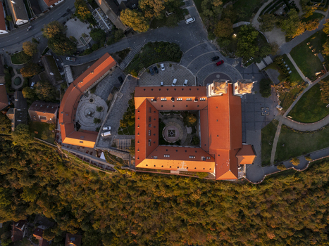 Aerial view of Tihany Abbey with its distinctive red tiled roofs and central courtyard surrounded by lush trees during the golden hour in Tihany Hungary. Aerial view of Tihany Abbey with its distinctive red tiled roofs and central courtyard surrounded by lush trees during the golden hour in Tihany Hungary.
