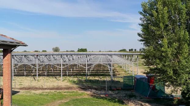 Aerial view of solar panel framework in a rural field Italy.