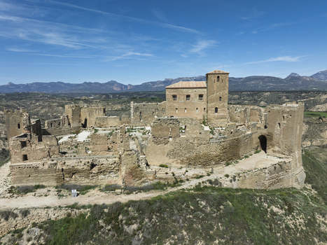 Aerial view of Castle Montearagon a historic medieval fortress with stone walls and towers set on a hill overlooking the rugged landscape of Quicena Aragon Spain.