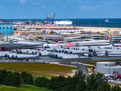 Aerial view of Siemens Gamesa Renewable Energy facility with rows of wind turbine blades stored in the industrial port of Cuxhaven Niedersachsen Germany.