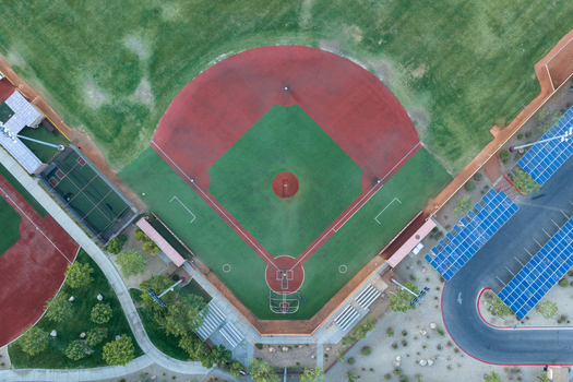 Aerial view of the baseball field at Sports Town USA with red dirt infield green grass outfield and adjacent solar panel parking structures in Las Vegas Nevada United States. Aerial view of the baseball field at Sports Town USA with red dirt infield green grass outfield and adjacent solar panel parking structures in Las Vegas Nevada United States.