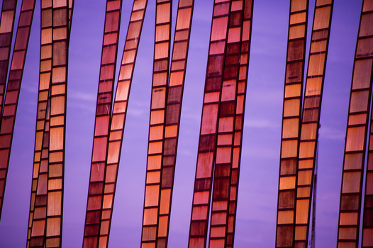 View of the metallic textured exterior panels of the Museum of Pop Culture against a vibrant purple sky in Seattle Washington United States.