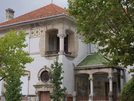 View of a historic building with ornate architectural details tiled facade and a balcony in Covilha Castelo Branco District Portugal.