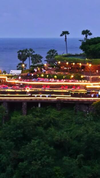 Aerial view of cliffside resort at dusk in Bali Indonesia.