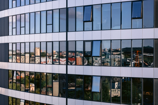 Aerial view of a modern glass building facade reflecting the urban landscape of the city in Vilnius Vilnius County Lithuania.