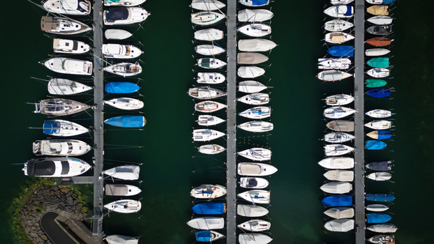 Aerial view of boats docked in the marina their white hulls contrasting with the dark green water Neuchâtel Neuchâtel Switzerland. Aerial view of boats docked in the marina their white hulls contrasting with the dark green water Neuchâtel Neuchâtel Switzerland.