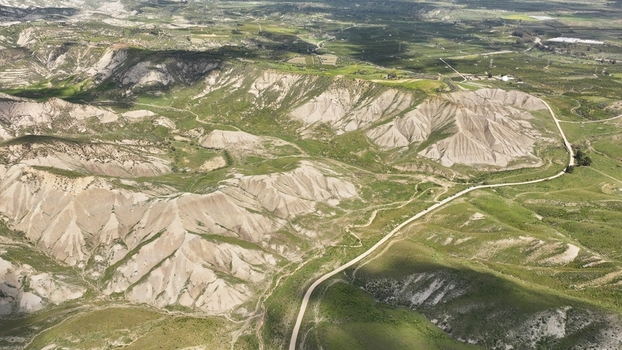 Aerial view of a stark landscape where the rugged earth rises in dramatic ridges punctuated by patches of verdant life Centuripe Sicilia Italy. Aerial view of a stark landscape where the rugged earth rises in dramatic ridges punctuated by patches of verdant life Centuripe Sicilia Italy.