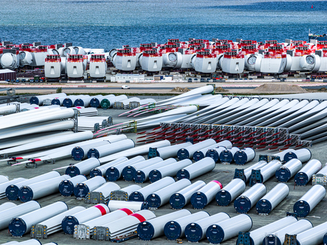Aerial view of Siemens Gamesa Renewable Energy wind turbine blades and nacelles stored at the industrial port facility in Cuxhaven Niedersachsen Germany.