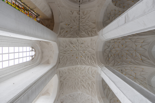 View of the intricate star vaulted ceiling with white stone ribs and gold accents inside the historic St. Mary s Church in Gdansk Pomeranian Voivodeship Poland. View of the intricate star vaulted ceiling with white stone ribs and gold accents inside the historic St. Mary s Church in Gdansk Pomeranian Voivodeship Poland.