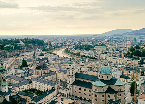 View of Salzburg Cathedral and the historic city center with the Salzach River winding through the urban landscape in Salzburg Salzburg Austria. View of Salzburg Cathedral and the historic city center with the Salzach River winding through the urban landscape in Salzburg Salzburg Austria.