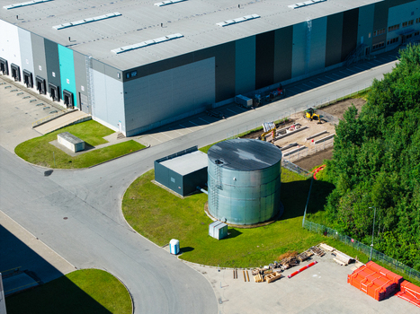 Lielvarzi Kekava Municipality Latvia 05 July 2026 Aerial view of VGP Park Kekava warehouse featuring a large metal water tank paved access roads and adjacent green forest area. Lielvarzi Kekava Municipality Latvia 05 July 2026 Aerial view of VGP Park Kekava warehouse featuring a large metal water tank paved access roads and adjacent green forest area.