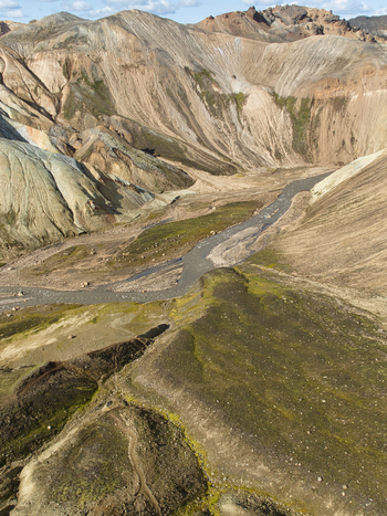 Aerial view of the colorful rhyolite mountains and winding river in the volcanic landscape of Landmannalaugar in Hella Rangarthing ytra Iceland. Aerial view of the colorful rhyolite mountains and winding river in the volcanic landscape of Landmannalaugar in Hella Rangarthing ytra Iceland.