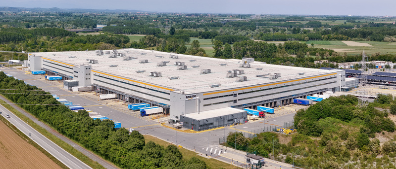 Torrazza Piemonte Italy 02 May 2026 Aerial view of Amazon TRN1 fulfillment center with trucks at loading docks and surrounding green landscape. Torrazza Piemonte Italy 02 May 2026 Aerial view of Amazon TRN1 fulfillment center with trucks at loading docks and surrounding green landscape.
