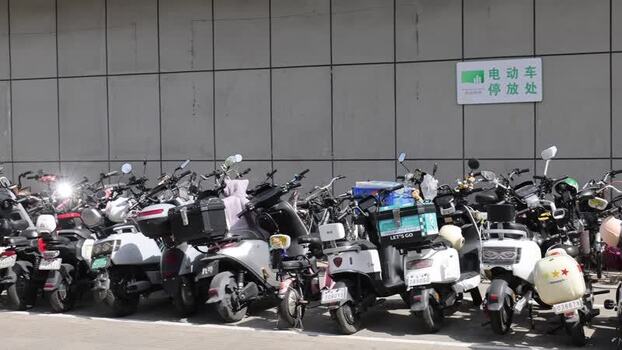View of electric scooters parked in Shenzhen China. View of electric scooters parked in Shenzhen China.