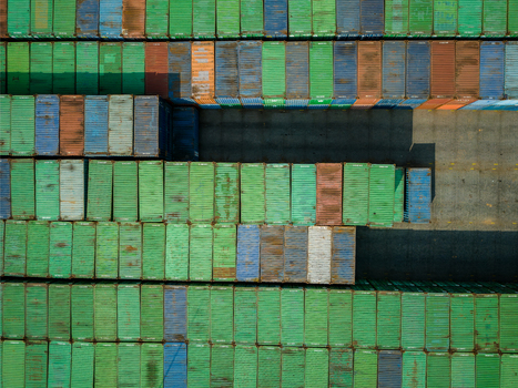 Aerial view of numerous colorful shipping containers neatly stacked in a large industrial storage yard in Boyolali Central Java Indonesia.