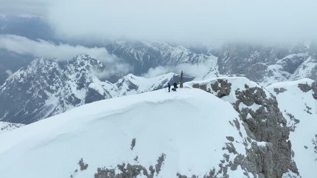 Aerial view of people on a snowy mountain ridge Italy.