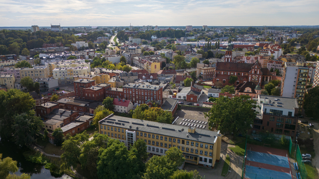 Aerial view of a vibrant cityscape where the red brick buildings and the historic church stand as testaments to time amidst the verdant canopy Bydgoszcz Województwo kujawsko pomorskie Poland. Aerial view of a vibrant cityscape where the red brick buildings and the historic church stand as testaments to time amidst the verdant canopy Bydgoszcz Województwo kujawsko pomorskie Poland.