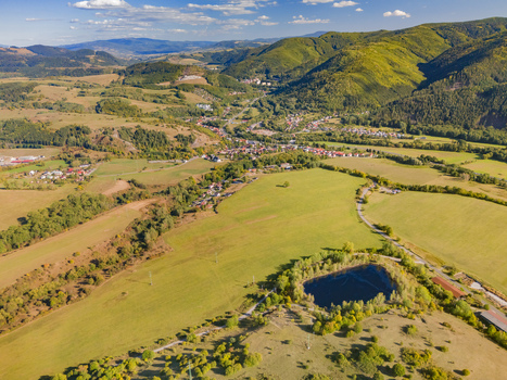 Aerial view of the acid tar lagoons near Predajna surrounded by green fields and the rolling hills of the Low Tatras in Predajna Banskobystricky kraj Slovakia. Aerial view of the acid tar lagoons near Predajna surrounded by green fields and the rolling hills of the Low Tatras in Predajna Banskobystricky kraj Slovakia.