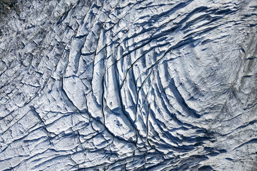 Aerial view of the intricate patterns etched into the icy expanse of Morteratsch Glacier a frozen river winding through the Swiss Alps Morteratsch Glacier Grisons Switzerland. Aerial view of the intricate patterns etched into the icy expanse of Morteratsch Glacier a frozen river winding through the Swiss Alps Morteratsch Glacier Grisons Switzerland.
