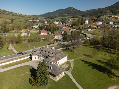 Aerial view of Kastiel Kubinyi manor house with the village of Vysny Kubin and Velky Choc mountain on the horizon in Vysny Kubin Zilinsky kraj Slovakia.
